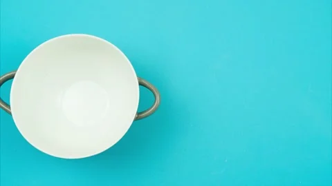 Frame-by-frame animation of a cookie of chocolate pads filling a bowl. Stock Footage 136849379
