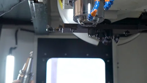 In the frame of the hand of the engineer and the mill for the CNC machine. Stock Footage 99134463