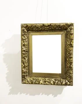 Frame hangs on string against wall with blank center. Suspended border presen Stock Photos