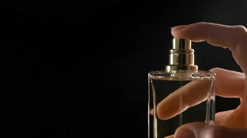 Frame macro spraying perfume on a dark background Stock Footage 225239124
