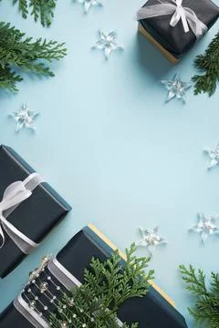 Frame made of blue gift boxes with white ribbon and transparent beads on a bl Stock Photos
