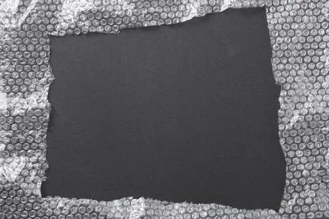 Frame made of bubble wrap on black background, top view. Space for text Stock Photos