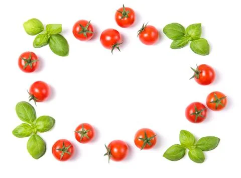 Frame made of cherry tomatoes with basil leaves, isolated on white background Foto stock