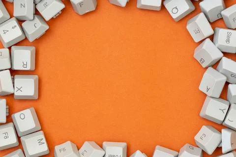 Frame made of computer keyboard keys on the orange background Stock Photos