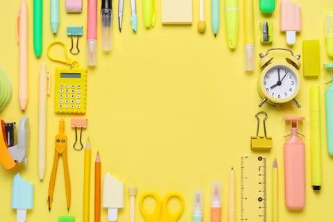 Frame made of different school stationery supplies and alarm clock on yellow  Stock Photos