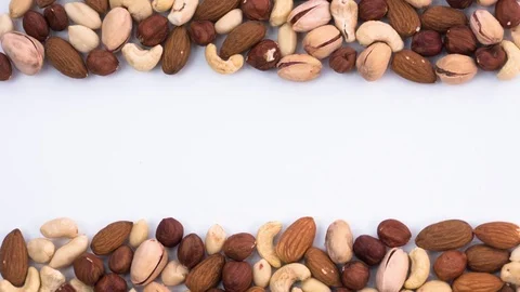 Frame made of different types of nuts. Stop motion Video stock 72683959