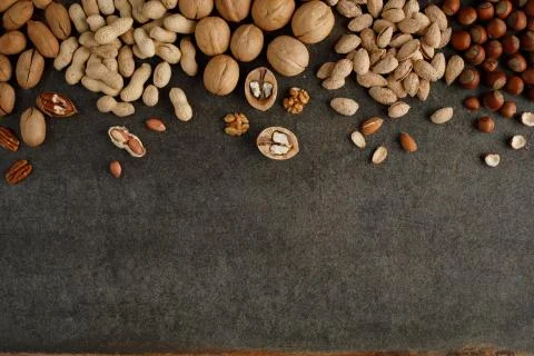 Frame made of different types of nuts on stone background Stock Photos