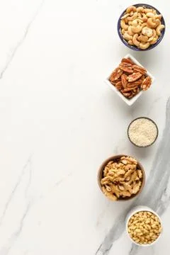 Frame made of different types of nuts in bowls Stock Photos