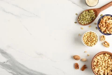 Frame made of different types of nuts in bowls Stock Photos