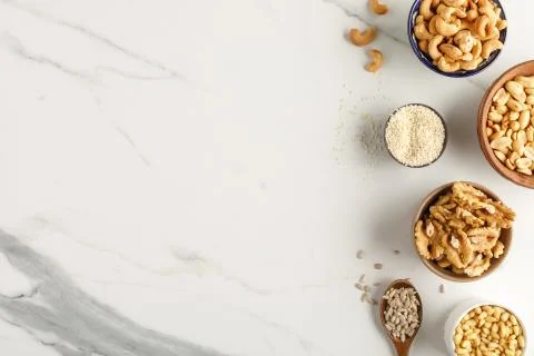 Frame made of different types of nuts in bowls Stock Photos