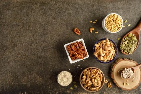 Frame made of different types of nuts in bowls Stock Photos