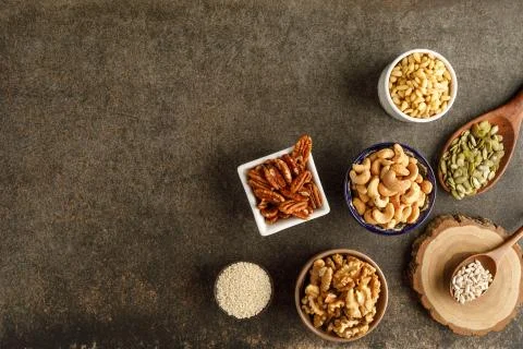 Frame made of different types of nuts in bowls Stock Photos