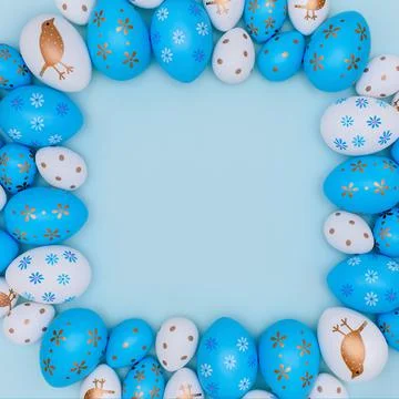 Frame made of Easter eggs on blue background. 스톡 사진