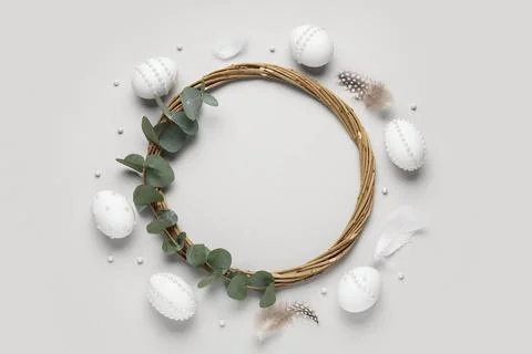 Frame made of Easter eggs decorated with pearls, wreath, feathers and eucalyp Stock Photos