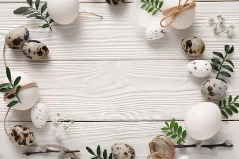 Frame made of Easter eggs with leaves, gypsophila flowers and pussy willow br Stock Photos