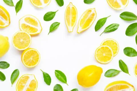 Frame made of fresh lemon with green leaves on white. Stock Photos