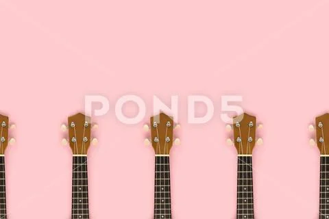Frame made of guitar fretboards on a pink pastel background. Stock Photos
