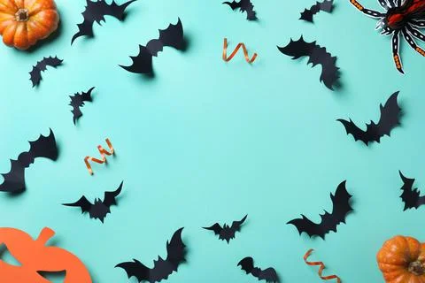 Frame made with Halloween decor elements on light blue background, flat lay.  Stock Photos