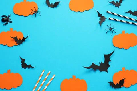 Frame made with Halloween decor elements on light blue background, above view Fotos Stock