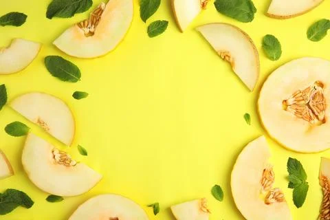 Frame made of melon and mint leaves with space for text on color background,  Stock Photos
