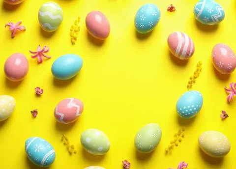 Frame made of painted Easter eggs on color background, space for text Stock Photos