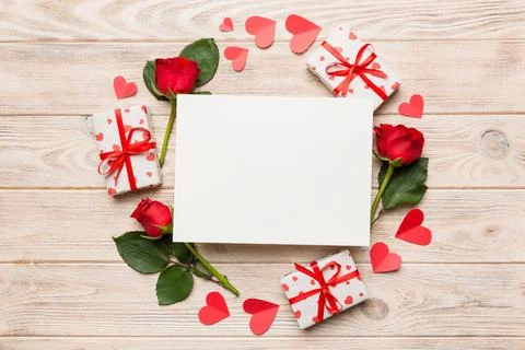 Frame made of rose, git box, heart and blank greeting card mockup on Colored  写真素材