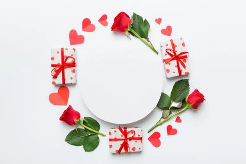 Frame made of rose, git box, heart and blank greeting card mockup on Colored  写真素材