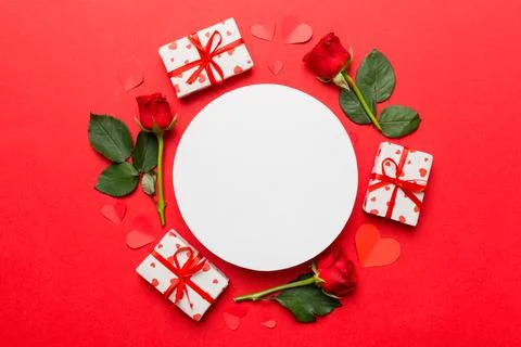 Frame made of rose, git box, heart and blank greeting card mockup on Colored  写真素材