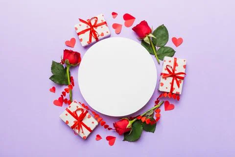 Frame made of rose, git box, heart and blank greeting card mockup on Colored  写真素材
