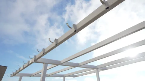 Frame of pavilion stands under sky dotted with fluffy clouds 動画素材 310604265