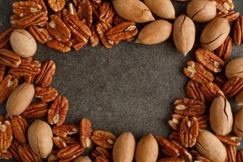 Frame of pecan nuts on marble background. Stock Photos
