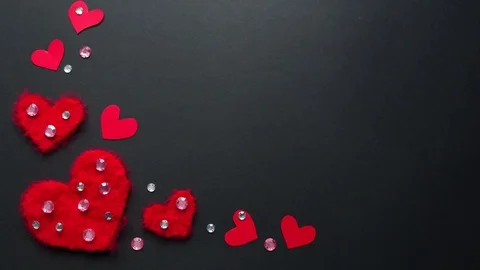 Frame of red wool hearts on a black background.  Stock Footage 72285083