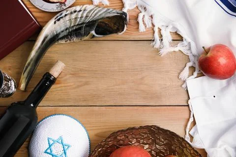 Frame of Rosh Hashanah holiday attributes on wooden table, flat lay. Space fo Stock Photos