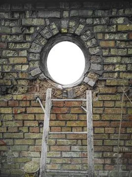 Frame in the shape of a circle window lined with old, aged damaged yellow bri Stock Photos