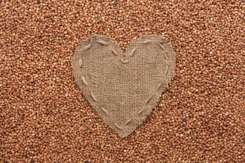 Frame in the shape of heart made of burlap with buckwheat Stock-Fotos