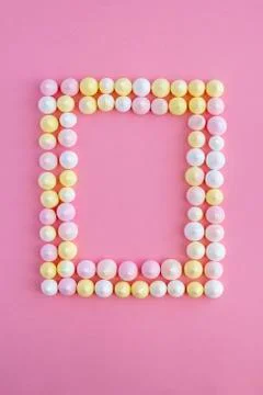Frame in the shape of a rectangle of meringue on a pink background 스톡 사진