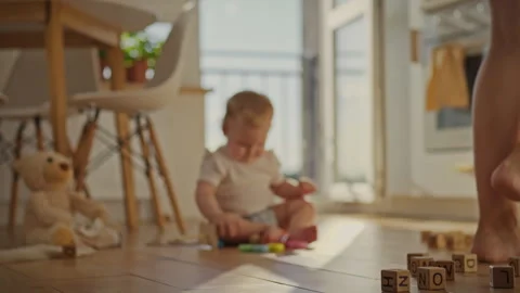The frame shows a close-up of the legs of a young girl who walks around the Stock Footage 283683712