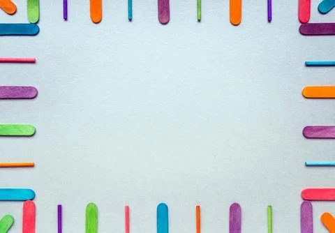 Frame with straight multicolored rounded flat sticks. Stock Photos