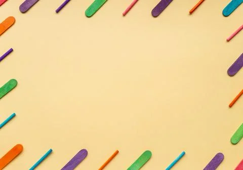 Frame with tilt multicolored rounded flat sticks. Stock Photos