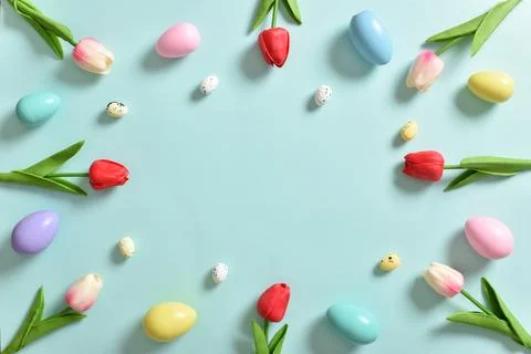 Frame with tulip flowers, Easter colored eggs. Decor for the feast of Holy Ea Stock Photos