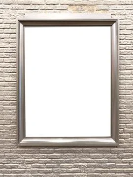 A frame with a white background hangs on a brick wall Stock Photos