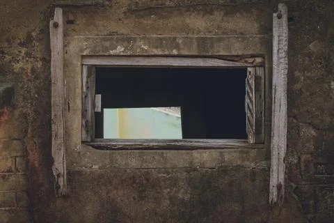 Frame within a frame through an old window having broken window shutter Stock Photos