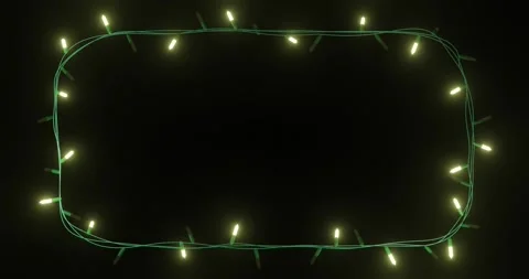 Frame of yellow christmas string lights flashing on black background, copy space Stock Footage 253158383