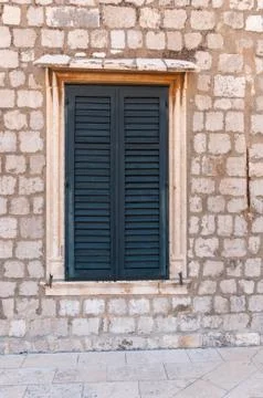 Framed ancient window with shutters Stock Photos