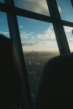 Framed cityscape view through large glass windows at dusk Stock Photos