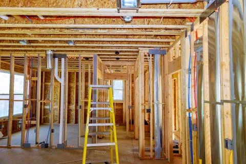 Framed residential home with basic rough plumbing completed on new constructi 스톡 사진