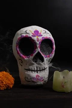 Framed, text-safe still life of a hand-painted papier mache sugar skull with  Stock Photos