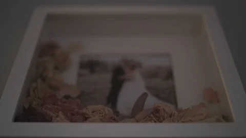 Framed wedding couple photo with dried bouquet flowers in frame Stock-Footage 128317355