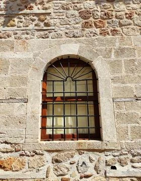 Framed windows on the stone facade of an old house Stock Photos