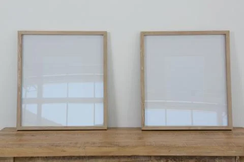 Frames arranged on wooden table Stock Photos